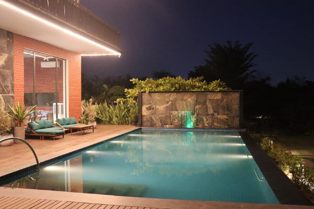 Pool lit up at night at BreakSpot Villa, Aziz Nagar, Moinabad